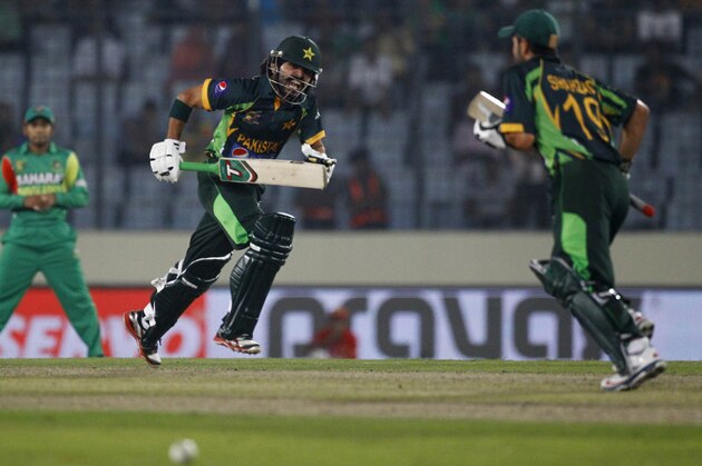 Pakistan’s Fawad Alam, left, and Ahmed Shehzad run between the wickets during their match against Bangladesh in the Asia Cup one-day international cricket tournament in Dhaka, Bangladesh, Tuesday, March 4, 2014. (AP Photo/A.M. Ahad)