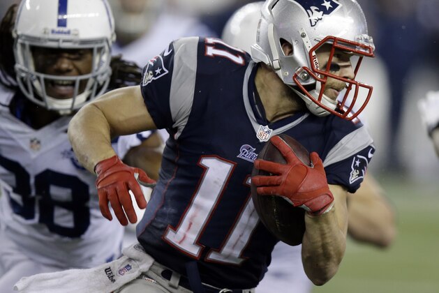 New England Patriots wide receiver Julian Edelman (11) runs from Indianapolis Colts defensive back Sergio Brown (38) after a catch during the second half of an AFC divisional NFL playoff football game in Foxborough, Mass., Saturday, Jan. 11, 2014. (AP Photo/Stephan Savoia)
