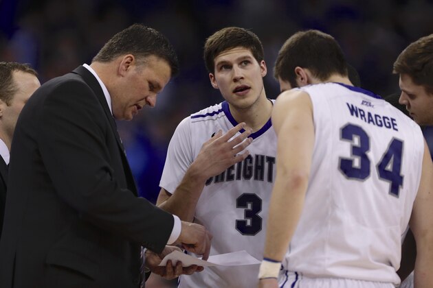 Creighton coach Greg McDermott looks at his notes with Doug McDermott (3) and Ethan Wragge (34) in the second half of an NCAA college basketball game against Seton Hall in Omaha, Neb., Sunday, Feb. 23, 2014. Creighton won 72-71. (AP Photo/Nati Harnik)