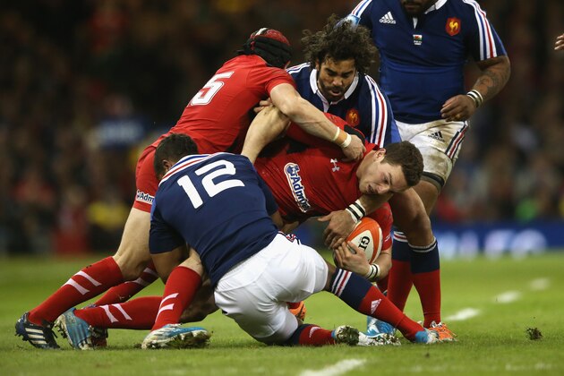 CARDIFF, WALES - FEBRUARY 21:  George North of Wales is tackled by Yoann Huget and Wesley Fofana (12) during the RBS Six Nations match between Wales and France at the Millennium Stadium on February 21, 2014 in Cardiff, Wales.  (Photo by David Rogers/Getty Images)