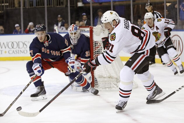 New York Rangers defenseman Ryan McDonagh (27) defends as Chicago Blackhawks right wing Marian Hossa (81), of Slovakia, tries to take a shot in the third period of an NHL hockey game at Madison Square Garden in New York, Thursday, Feb. 27, 2014. The Rangers defeated the Blackhawks 2-1. (AP Photo/Kathy Willens)