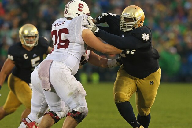 SOUTH BEND, IN - OCTOBER 13:  Louis Nix III #9 of the Notre Dame Fighting Irish rushes against Kevin Danser #76 of the Standford Cardinal at Notre Dame Stadium on October 13, 2012 in South Bend, Indiana. Notre Dame defeated Stanford 20-13 in overtime.  (Photo by Jonathan Daniel/Getty Images)