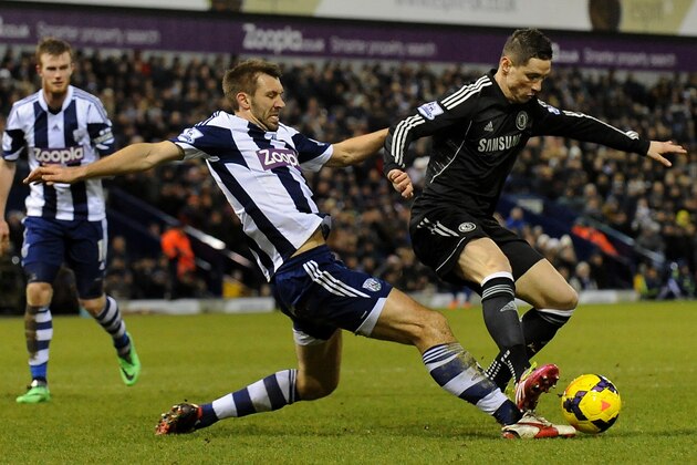 West Brom's Gareth McAuley, left, competes for the ball with Chelsea's  Fernando Torres during the English Premier League soccer match between West Bromwich Albion and Chelsea at The Hawthorns Stadium in West Bromwich, England, Tuesday, Feb. 11, 2014.  (AP Photo/Rui Vieira)