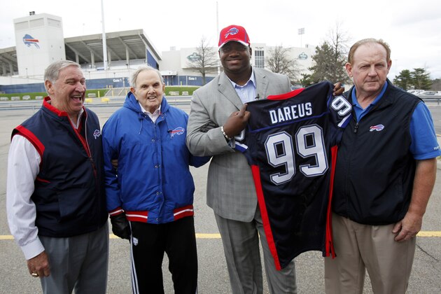 Buffalo Bills first round draft pick Marcell Dareus, center, poses for a photo with Bills owner Ralph Wilson Jr., left center, coach Chan Gailey, right, and general manager Buddy Nix, left, before an introductory NFL football news conference in Orchard Park, N.Y., Friday, April 29, 2011. (AP Photo/David Duprey)