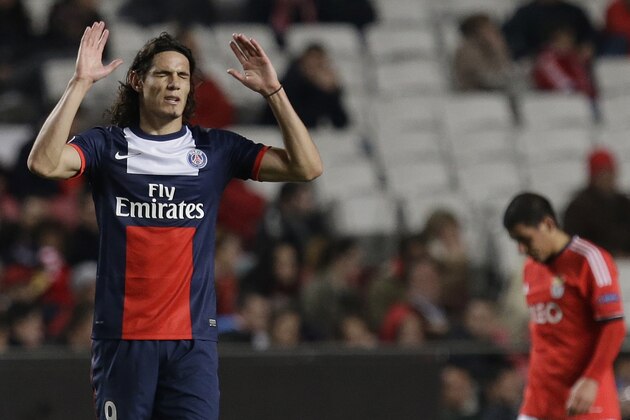 PSG's Edinson Cavani, left raises his hands after scoring the opening goal during a Group C Champions League soccer match between Benfica and PSG at the Luz stadium in Lisbon, Tuesday Dec. 10, 2013.(AP Photo/Armando Franca)