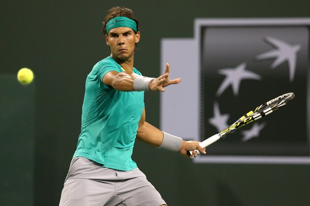 INDIAN WELLS, CA - MARCH 14:  Rafael Nadal of Spain hits a return to Roger Federer of Switzerland during day 9 of the BNP Paribas Open at Indian Wells Tennis Garden on March 14, 2013 in Indian Wells, California.  Nadal won 6-4, 6-2.  (Photo by Stephen Dunn/Getty Images)