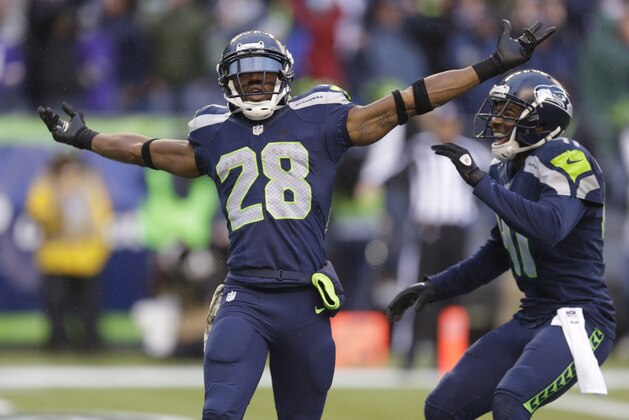 In this Nov. 17, 2013, photo, Seattle Seahawks' Byron Maxwell, right, smiles as he joins Walter Thurmond after Thurmond's interception and touchdown against the Minnesota Vikings during an NFL football game in Seattle. Thurmond is returning from his four-game suspension just in time to join the Seahawks for the postseason. But Thurmond has lost the starting spot he had before the suspension arrived. Thurmond is expected to be activated to Seattle's roster before Sunday's game against St. Louis. (AP Photo/Ted S. Warren)