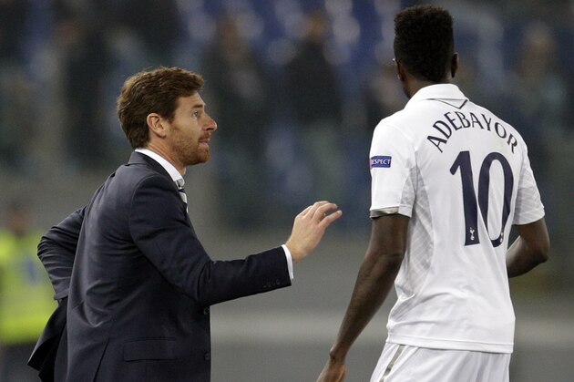 Tottenham Hotspur coach Andre Villas-Boas of Portugal, left, talks with forward Emmanuel Adebayor of Togo during an Europa League Group J soccer match between Lazio and Tottenham Hotspur, at Rome's Olympic stadium, Thursday, Nov. 22, 2012. (AP Photo/Andrew Medichini)
