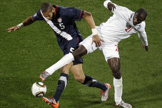 United States' Oguchi Onyewu, left, competes for the ball with England's Emile Heskey, right, during the World Cup group C soccer match between England and the United States at Royal Bafokeng Stadium in Rustenburg, South Africa, on Saturday, June 12, 2010.  (AP Photo/Michael Sohn)