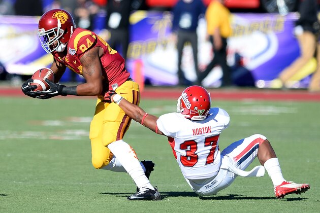 LAS VEGAS, NV - DECEMBER 21:  Darreus Rogers #84 of the USC Trojans breaks a tackle by Jonathan Norton #37 of the Fresno State Bulldogs during the Royal Purple Las Vegas Bowl at Sam Boyd Stadium on December 21, 2013 in Las Vegas, Nevada.  (Photo by Ethan Miller/Getty Images)