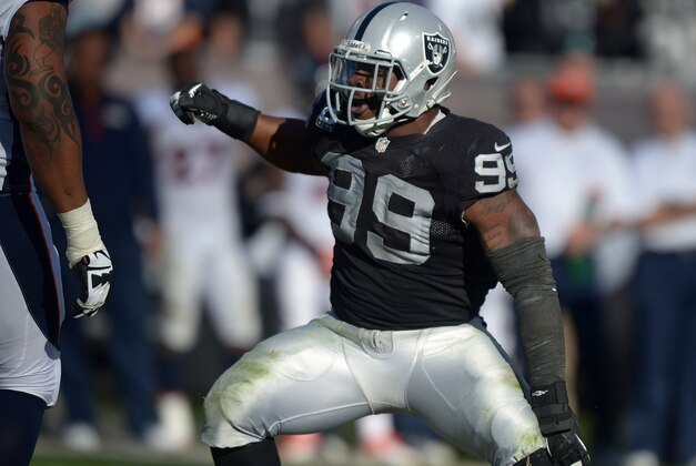 Dec 29, 2013; Oakland, CA, USA; Oakland Raiders defensive end Lamarr Houston (99) reacts during the game against the Denver Broncos at O.co Coliseum. The Broncos won 34-14. Mandatory Credit: Kirby Lee-USA TODAY Sports