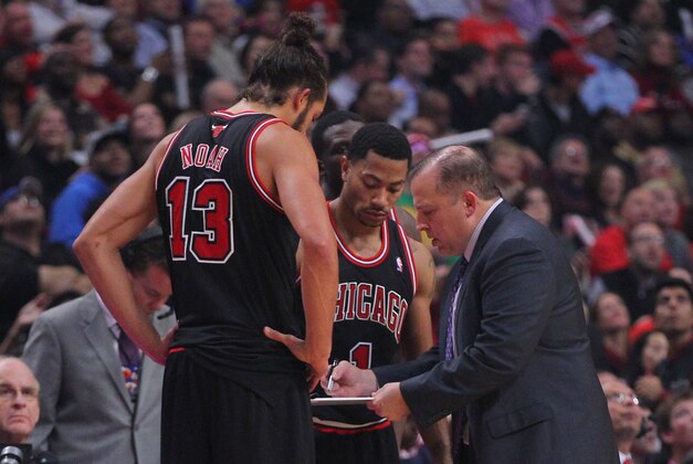 Oct 31, 2013; Chicago, IL, USA; Chicago Bulls center Joakim Noah (left) and point guard Derrick Rose (center) talk with head coach Tom Thibodeau (right) during the second quarter at United Center. Mandatory Credit: Dennis Wierzbicki-USA TODAY Sports