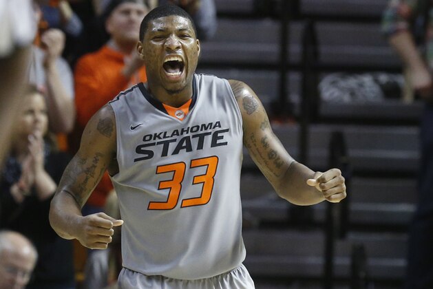 Oklahoma State guard Marcus Smart (33) celebrates during the second half of an NCAA college basketball game against Kansas in Stillwater, Okla., Saturday, March 1, 2014. Oklahoma State won 72-65. (AP Photo/Sue Ogrocki)