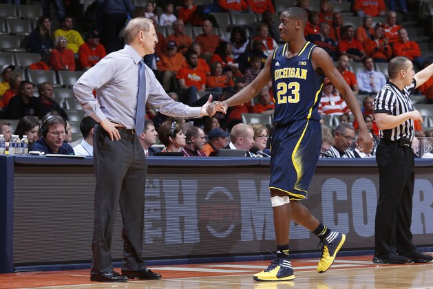 CHAMPAIGN, IL - MARCH 4: Head coach John Beilein of the Michigan Wolverines congratulates Caris LeVert #23 during the game against the Illinois Fighting Illini at State Farm Center on March 4, 2014 in Champaign, Illinois. Michigan defeated Illinois 84-53. (Photo by Joe Robbins/Getty Images) CHAMPAIGN, IL - MARCH 4: Head coach John Beilein of the Michigan Wolverines congratulates Caris LeVert #23 during the game against the Illinois Fighting Illini at State Farm Center on March 4, 2014 in Champaign, Illinois. Michigan defeated Illinois 84-53. (Photo by Joe Robbins/Getty Images)