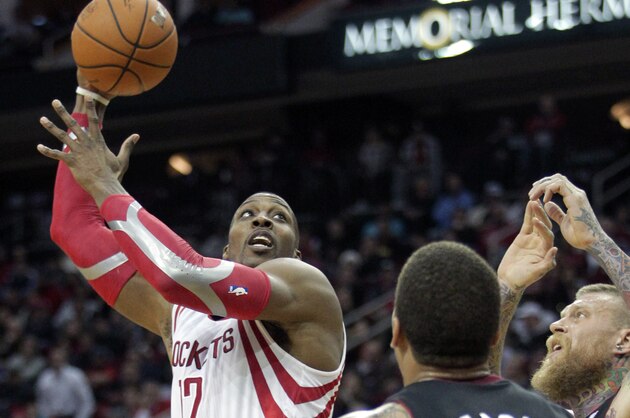 Houston Rockets center Dwight Howard takes a shot over Miami Heat forward Michael Beasley (8) during the fourth quarter of an NBA basketball game, Tuesday, March, 4, 2014, in Houston.  The Rockets defeated the Heat 106-103. (AP Photo/Patric Schneider)