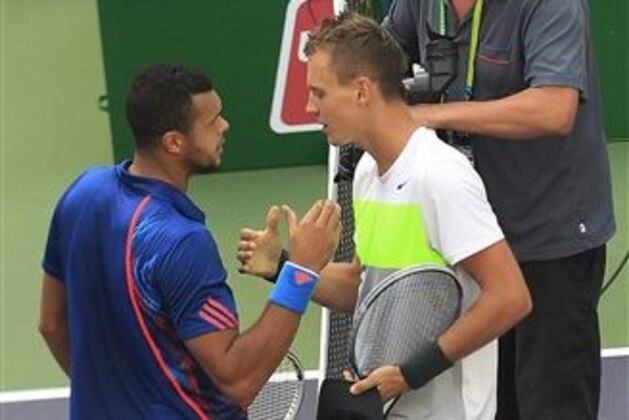 Tomas Berdych of the Czech Republic, right, and Jo-Wilfried Tsonga of France greet each other after their men's singles quarterfinal match at the Shanghai Masters tennis tournament at Qizhong Forest Sports City Tennis Center in Shanghai, China, Friday Oct. 12, 2012. Berdych won 6-3, 7-6 (4). (AP Photo/Eugene Hoshiko)