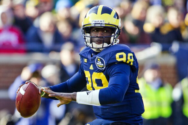 Michigan quarterback Devin Gardner (98) throws a pass in the first quarter of an NCAA college football game with Ohio State in Ann Arbor, Mich., Saturday, Nov. 30, 2013. (AP Photo/Tony Ding)