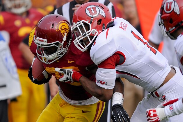 Southern California running back Silas Redd, left, is tackled by Utah defensive back Keith McGill (1) during the second half of an NCAA college football game, Saturday, Oct. 26, 2013, in Los Angeles. USC won 19- 3. (AP Photo/Gus Ruelas)