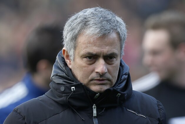 Chelsea's manager Jose Mourinho arrives at the dugout before the start of their English Premier League soccer match against Fulham, at Craven Cottage, London, Saturday, March 1, 2014. (AP Photo/Sang Tan)