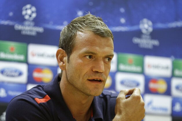 Olympiacos' Northern Ireland goalkeeper Roy Carroll speaking during a press conference at Arsenal's Emirates stadium in London,  Tuesday, Oct.  2  2012.  Olympiacos play Arsenal in a group B Champions League soccer match Wednesday.(AP Photo/Alastair Grant)