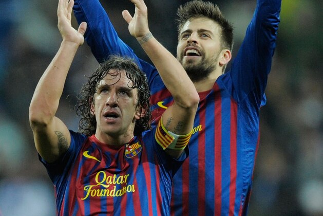 MADRID, SPAIN - DECEMBER 10:  Carles Puyol (L) and Gerard Pique celebrate after Barcelona beat Real Madrid 3-1 during the La Liga match between Real Madrid and Barcelona at Estadio Santiago Bernabeu on December 10, 2011 in Madrid, Spain.  (Photo by Denis Doyle/Getty Images)