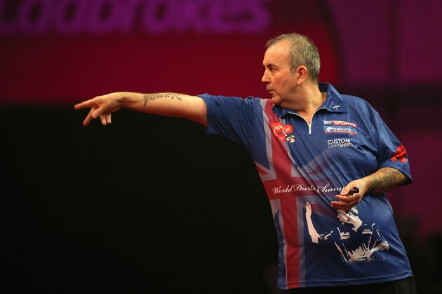 LONDON, ENGLAND - DECEMBER 20:  Phil Taylor of England throws during his second round match against Michael Smith of England during the Ladbrokes.com World Darts Championship on Day Eight at Alexandra Palace on December 20, 2013 in London, England. (Photo by Charlie Crowhurst/Getty Images)