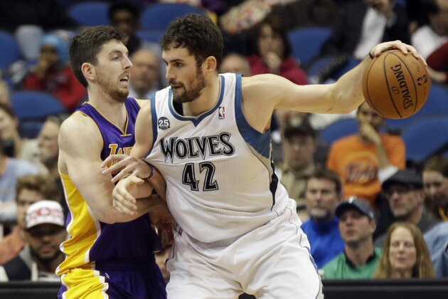 Los Angeles Lakers' Ryan Kelly, left, tries to slow down Minnesota Timberwolves' Kevin Love in the second half of an NBA basketball game against the Minnesota Timberwolves, Tuesday, Feb. 4, 2014, in Minneapolis. The Timberwolves won 109-99. The game marked the first for Nash since early November as he recovered from a back injury. (AP Photo/Jim Mone)