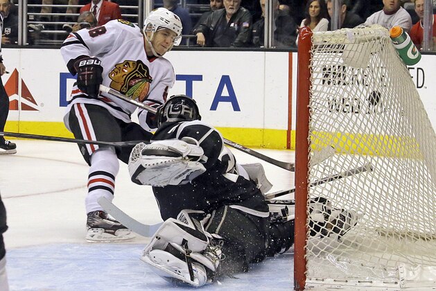 Chicago Blackhawks right winger Patrick Kane (88) tips the puck into the goal past Los Angeles Kings goalie Jonathan Quick (32) in the third period of an NHL hockey game in Los Angeles, Monday, Feb. 3, 2014. The Blackhawks won 5-3. (AP Photo/Reed Saxon)