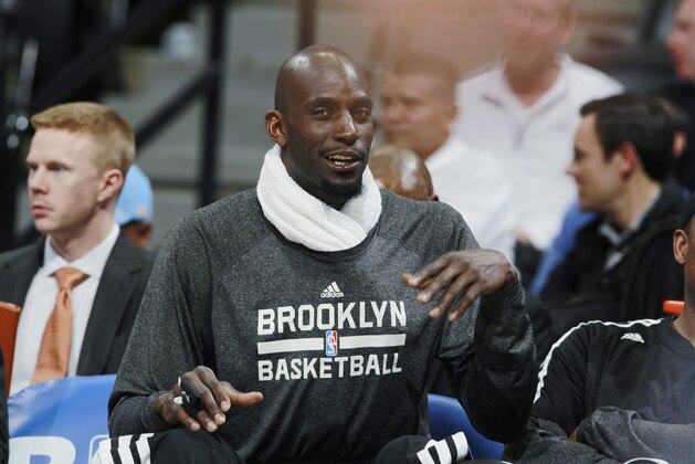 Brooklyn Nets forward Kevin Garnett looks on from bench as Nets face the Denver Nuggets in the fourth quarter of the Nets' 112-89 victory in an NBA basketball game in Denver on Thursday, Feb. 27, 2014. (AP Photo/David Zalubowski)