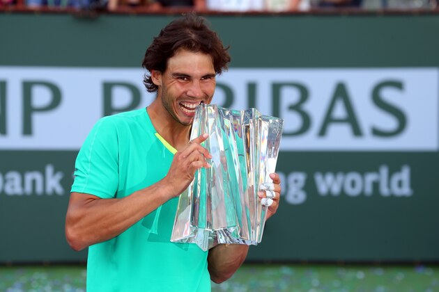INDIAN WELLS, CA - MARCH 17:  Rafael Nadal of Spain celebrates with the trophy after defeating Juan Martin Del Potro of Argentina to win the men's final match of the 2013 BNP Paribas Open at the Indian Wells Tennis Garden on March 17, 2013 in Indian Wells, California.  (Photo by Stephen Dunn/Getty Images)