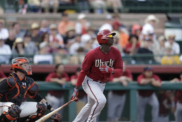 Arizona Diamondbacks' Didi Gregorius watches his fly ball while batting against the San Francisco Giants during the third inning of a spring training baseball game Sunday, March 2, 2014, in Scottsdale, Ariz. (AP Photo/Gregory Bull)