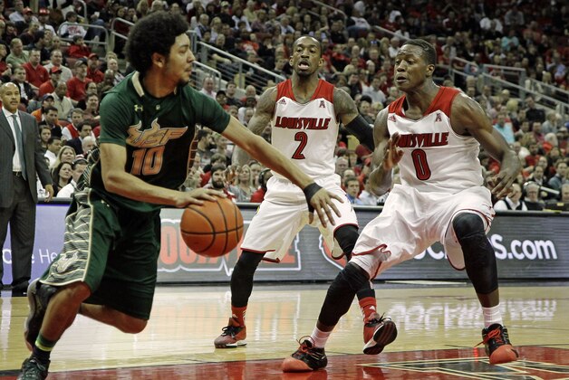 South Florida guard Josh Heath (10) works against Louisville defenders Russ Smith (2) and Terry Rozier (0) in their NCAA college basketball game in Louisville, Ky., Tuesday, Feb. 18, 2014. (AP Photo/Garry Jones)