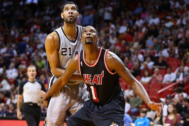 MIAMI, FL - JANUARY 26: Chris Bosh #1 of the Miami Heat boxes out Tim Duncan #21 of the San Antonio Spurs during a game  at American Airlines Arena on January 26, 2014 in Miami, Florida. NOTE TO USER: User expressly acknowledges and agrees that, by downloading and/or using this photograph, user is consenting to the terms and conditions of the Getty Images License Agreement. Mandatory copyright notice:  (Photo by Mike Ehrmann/Getty Images)