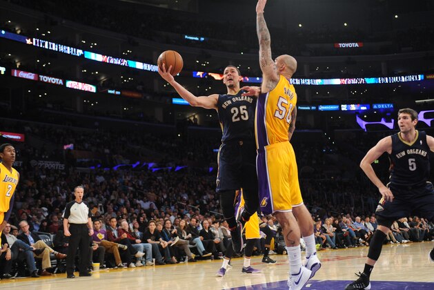LOS ANGELES, CA - MARCH 4: Austin Rivers #25 of the New Orleans Pelicans has his shot challenged by Robert Sacre #50 of the Los Angeles Lakers at Staples Center on March 4, 2014 in Los Angeles, California. NOTE TO USER: User expressly acknowledges and agrees that, by downloading and/or using this Photograph, user is consenting to the terms and conditions of the Getty Images License Agreement. Mandatory Copyright Notice: Copyright 2014 NBAE (Photo by Noah Graham/NBAE via Getty Images)
