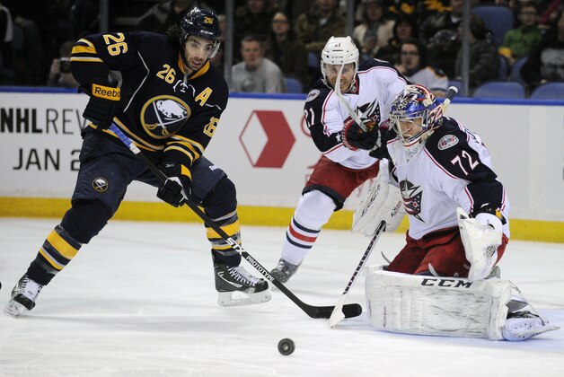 Buffalo Sabres left winger Matt Moulson (26) battles for a rebound as Columbus Blue Jackets defenseman James Wisniewski (21) and goaltender Sergei Bobrovsky (72), of Russia, defend during the first period of an NHL hockey game in Buffalo, N.Y., Saturday, Jan. 18, 2014. (AP Photo/Gary Wiepert)