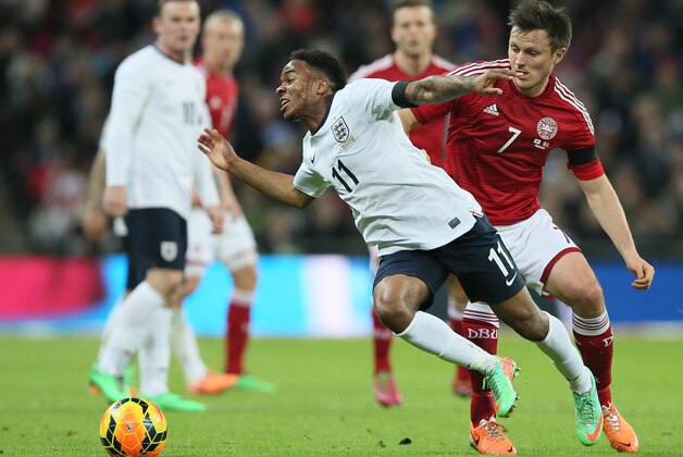 England's Raheem Sterling, left, falls as he is fouled by Denmark's William Kvist during the international friendly soccer match between England and Denmark at Wembley stadium in London Wednesday, March  5,  2014. (AP Photo/Alastair Grant)