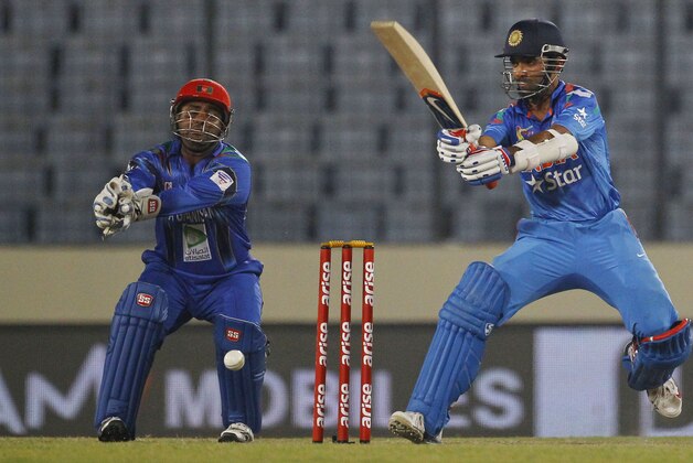 India’s Ajinkya Rahane, right, plays a shot as Afghanistan’s Mohammad Shahzad watches during their match in the Asia Cup one-day international cricket tournament in Dhaka, Bangladesh, Wednesday, March 5, 2014. (AP Photo/A.M. Ahad)