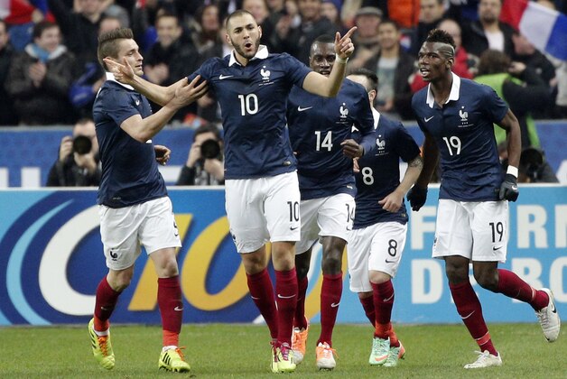 Karim Benzema of France, center, celebrates his goal with teammates during the international friendly match between France and Netherlands at the Stade de France stadium, outside Paris, Wednesday, March 5, 2014. (AP Photo/Christophe Ena)