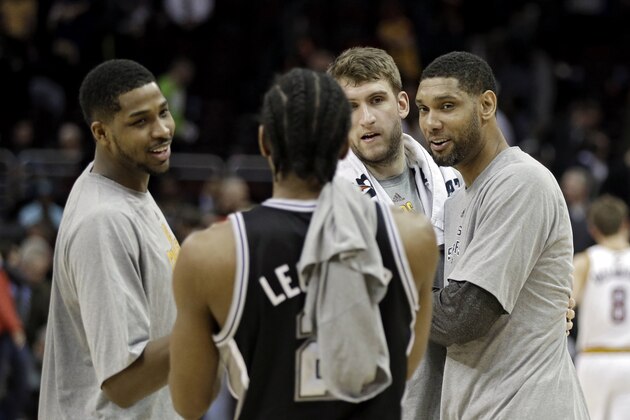 San Antonio Spurs' Tim Duncan, right, visits with Cleveland Cavaliers' Tristan Thompson, left, and Spencer Hawes after an NBA basketball game Tuesday, March 4, 2014, in Cleveland. (AP Photo/Mark Duncan)