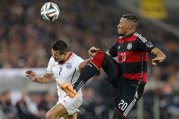Germany's Jerome Boateng, right, and Chile's Alexis Sanchez challenge for the ball during a   friendly soccer match between Germany and Chile in Stuttgart, Germany, Wednesday, March 5, 2014. (AP Photo/Michael Probst)