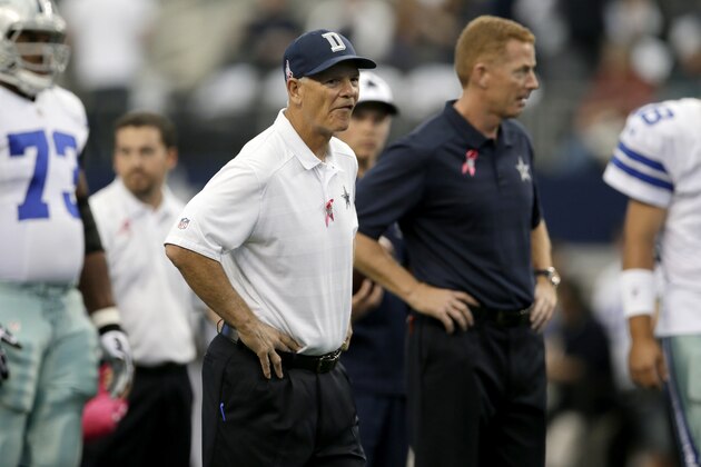 Dallas Cowboys defensive line coach Rod Marinelli, left, and head coach Jason Garrett, right, watch their team warm up before an NFL football game against the Denver Broncos, Sunday, Oct. 6, 2013, in Arlington, Texas. The Broncos won 51-48. (AP Photo/Tony Gutierrez)