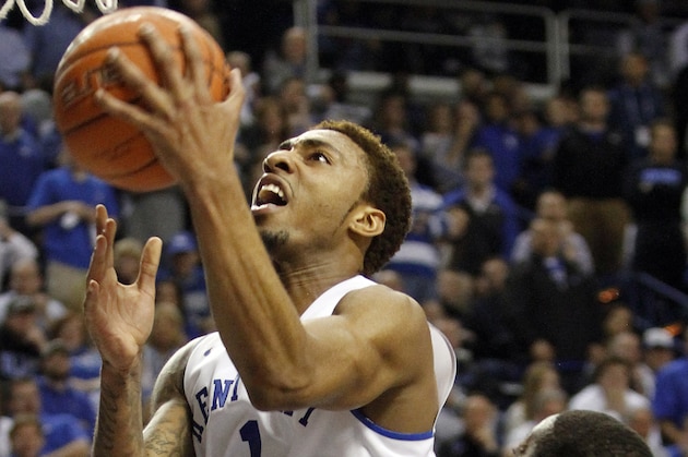 Kentucky's James Young (1) shoots as Florida's Dorian Finney-Smith watches during the first half of an NCAA college basketball game on Saturday, Feb. 15, 2014, in Lexington, Ky. (AP Photo/James Crisp)