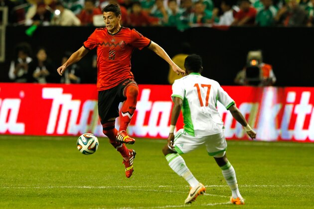 ATLANTA, GA - MARCH 05:  Hector Moreno #15 or Mexico attacks the ball against Ogenyi Onazi #17 of Nigeria at Georgia Dome on March 5, 2014 in Atlanta, Georgia.  (Photo by Kevin C. Cox/Getty Images)