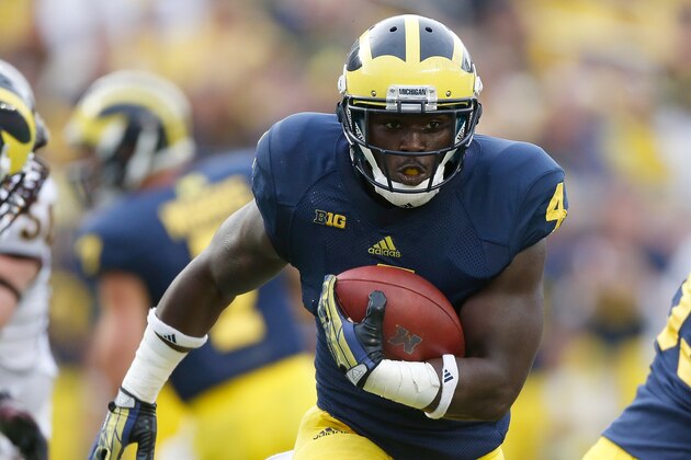 ANN ARBOR, MI - AUGUST 31: De'Veon Smith #4 of the Michigan Wolverines looks for extra yards during a fourth quarter run while playing the Central Michigan Chippewas at Michigan Stadium on August 31, 2013 in Ann Arbor, Michigan. Michigan won the 59-9. (Photo by Gregory Shamus/Getty Images)