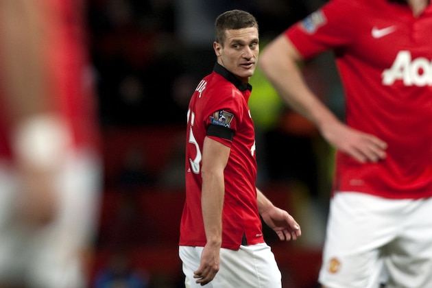 Manchester United's Nemanja Vidic walks down the pitch during his team's English Premier League soccer match against  Fulham at Old Trafford Stadium, Manchester, England, Sunday Feb. 9, 2014. (AP Photo/Jon Super)