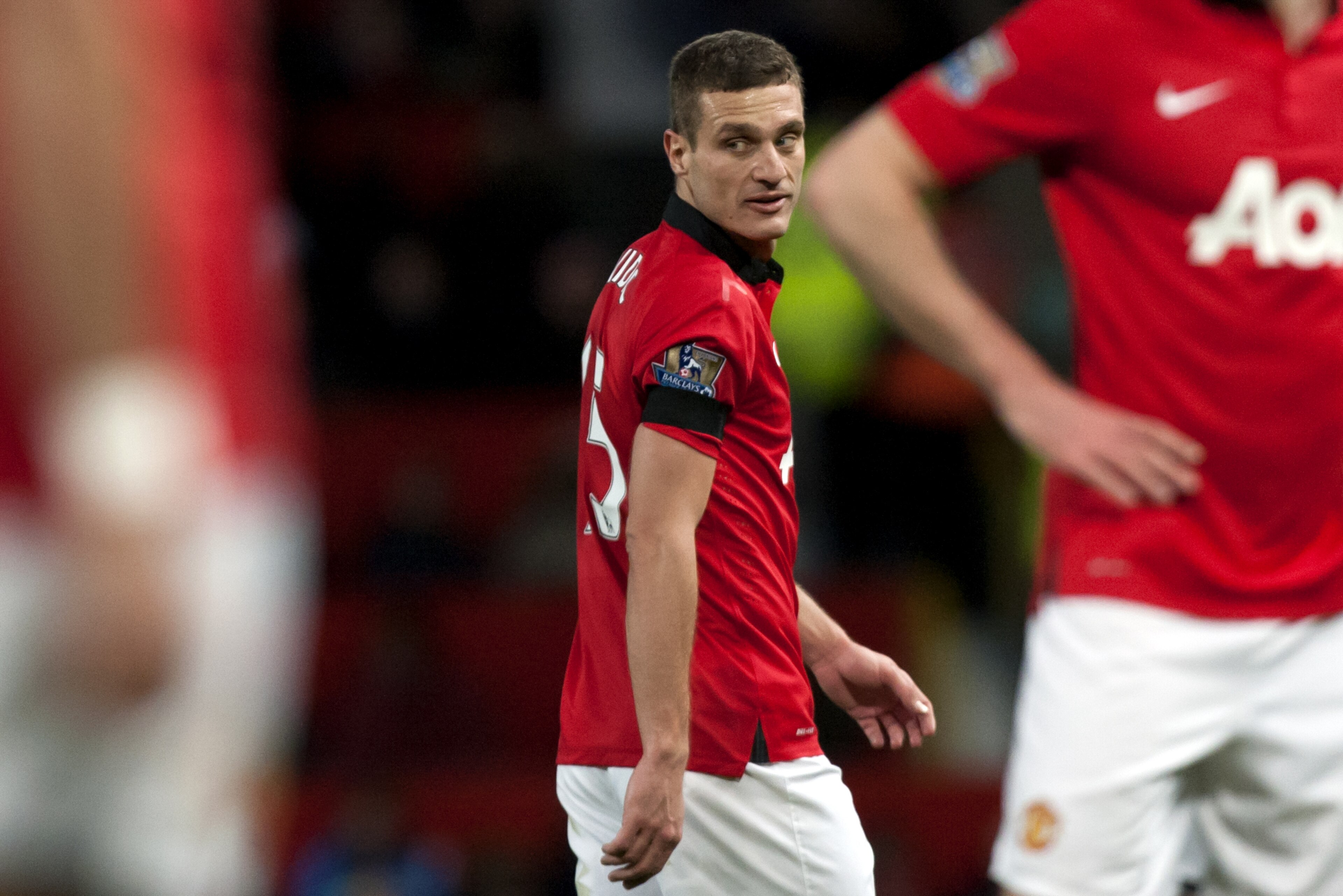 Manchester United's Nemanja Vidic walks down the pitch during his team's English Premier League soccer match against  Fulham at Old Trafford Stadium, Manchester, England, Sunday Feb. 9, 2014. (AP Photo/Jon Super)