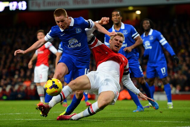 LONDON, ENGLAND - DECEMBER 08:  Per Mertesacker of Arsenal clashes with James McCarthy of Everton during the Barclays Premier League match between Arsenal and Everton at Emirates Stadium on December 8, 2013 in London, England.  (Photo by Michael Regan/Getty Images)