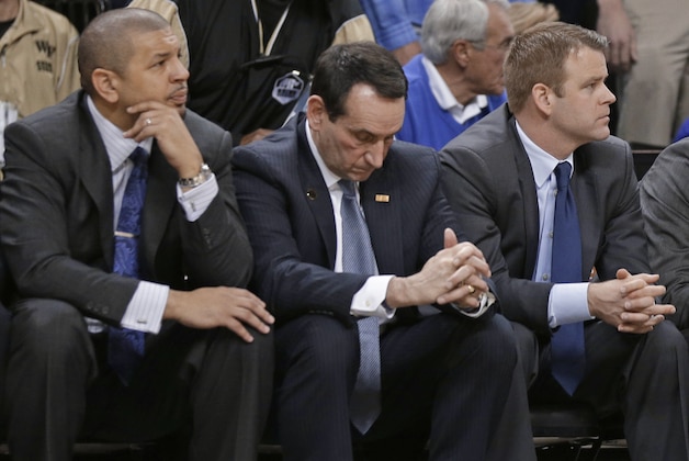 Duke coach Mike Krzyzewski, center, and assistant coaches Jeff Capel, left, and Steve Wojciechowski, right, watch the final minute of an NCAA college basketball game against Wake Forest in Winston-Salem, N.C., Wednesday, March 5, 2014. Wake Forest won 82-72. (AP Photo/Chuck Burton)