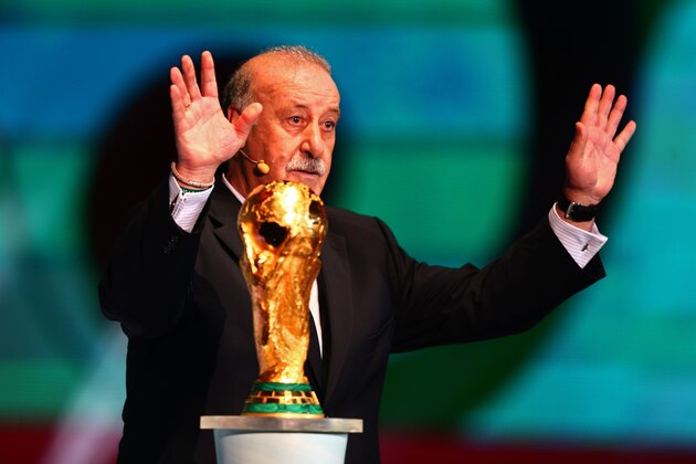 COSTA DO SAUIPE, BRAZIL - DECEMBER 06:  Spain coach Vicente del Bosque places the World Cup trophy on a plinth on stage before the Final Draw for the 2014 FIFA World Cup Brazil at Costa do Sauipe Resort on December 6, 2013 in Costa do Sauipe, Bahia, Brazil.  (Photo by Clive Mason/Getty Images)