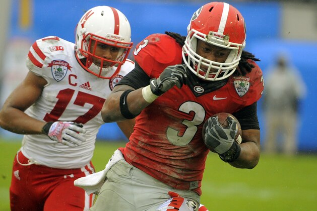 Georgia running back Todd Gurley (3) runs for yardage while being chased by Nebraska cornerback Ciante Evans (17) in the second half of the Gator Bowl NCAA college football game, Wednesday, Jan. 1, 2014, in Jacksonville, Fla. Nebraska beat Georgia 24-19. (AP Photo/Stephen B. Morton)